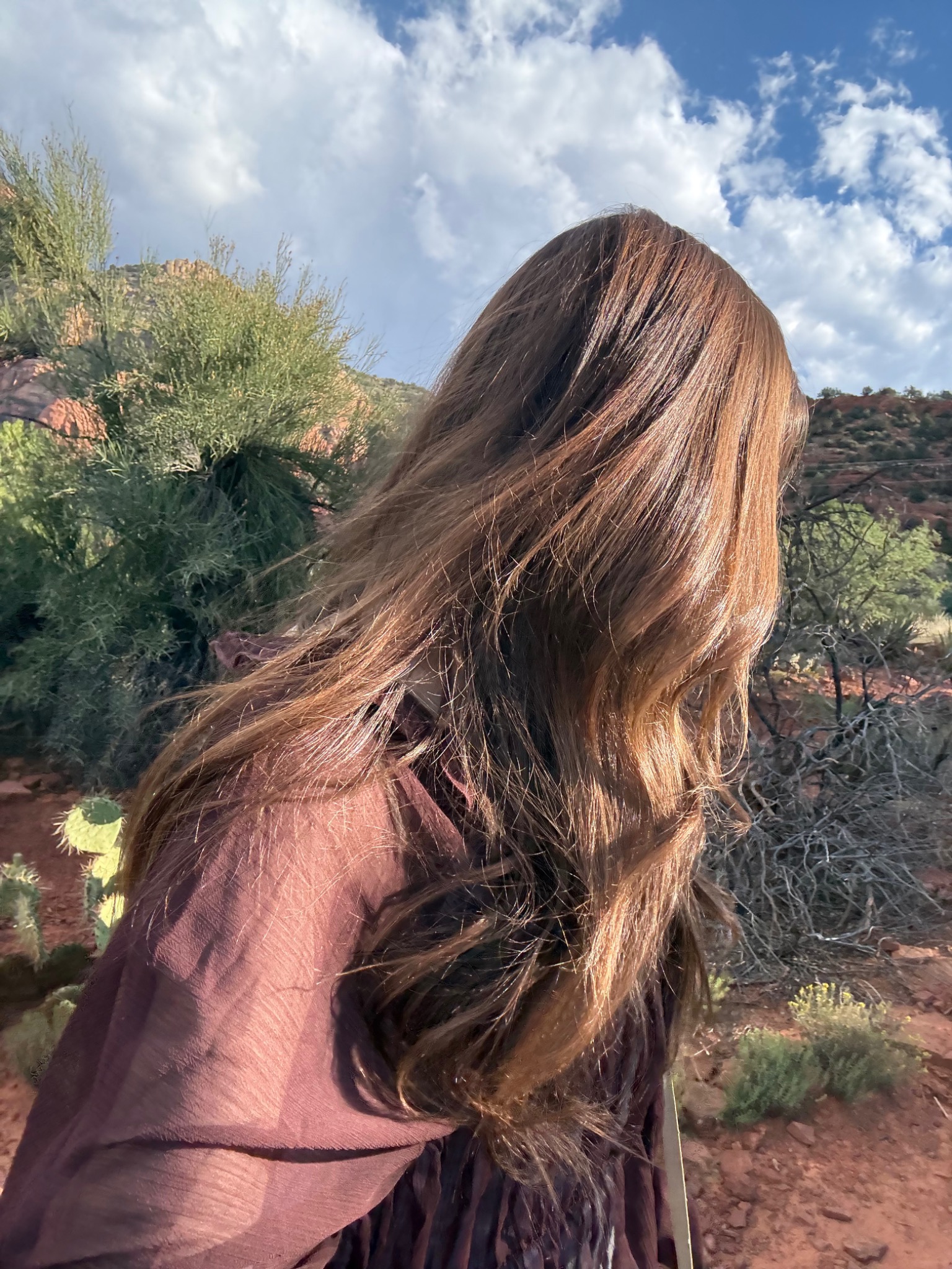 Jacquelyn in Sedona with her face turned away in warm natural light