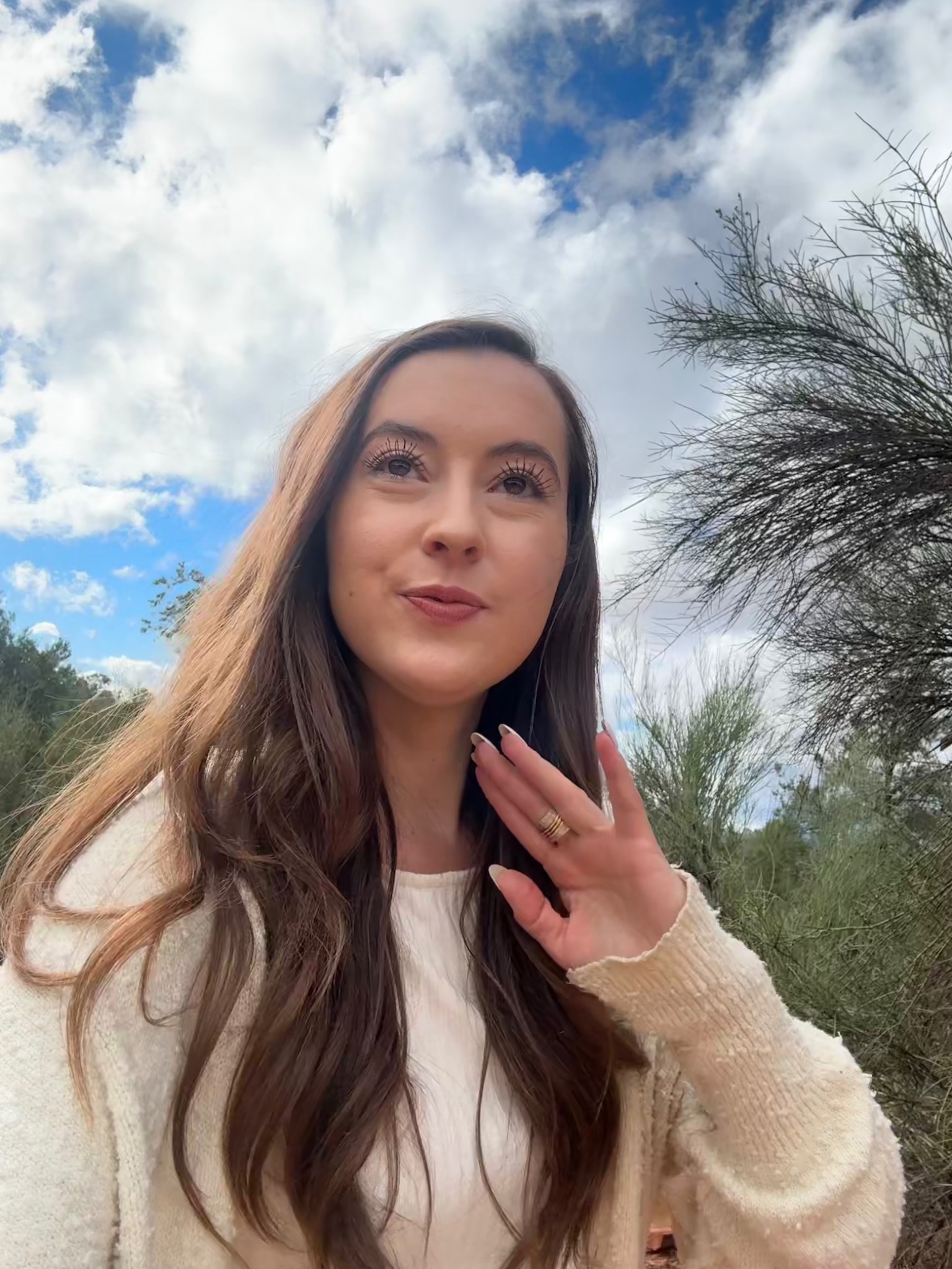 Jacquelyn outdoors beneath a bright sky for private sessions and integration